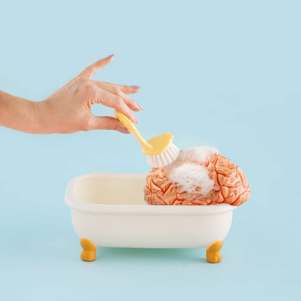 Hand,Of,Young,Woman,Washing,Human,Brain,With,Brush,In