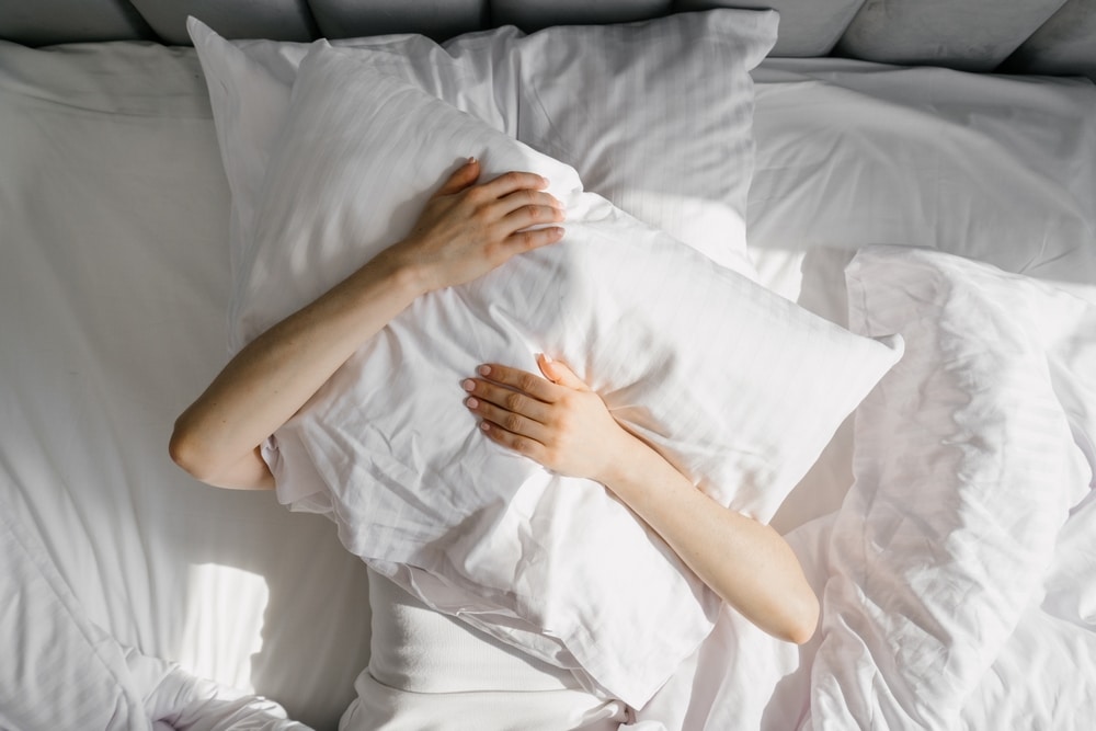 Female,Cover,Her,Head,With,Cushion,Suffers,From,Insomnia,Need